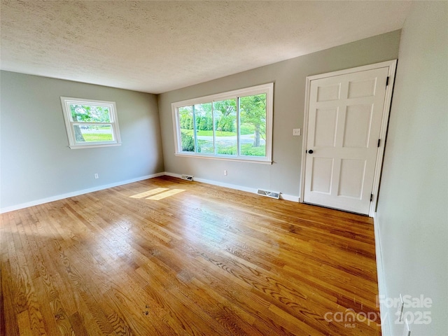 188 Johnston Blvd, Asheville, NC 28806 - empty room with wood finished floors, baseboards, and a textured ceiling