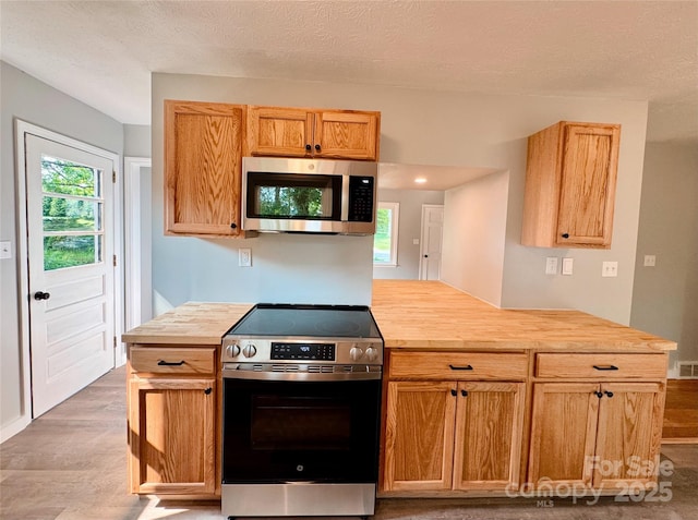 188 Johnston Blvd, Asheville, NC 28806 - kitchen featuring appliances with stainless steel finishes, light wood-style floors, wood counters, and a textured ceiling