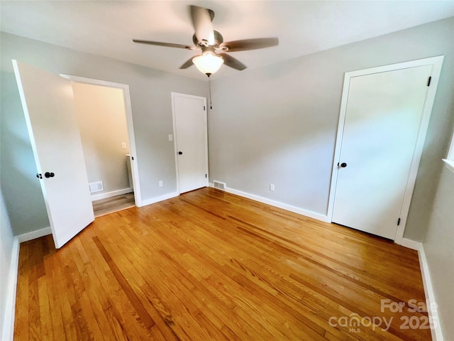 188 Johnston Blvd, Asheville, NC 28806 - unfurnished bedroom with light wood-type flooring, baseboards, and ceiling fan