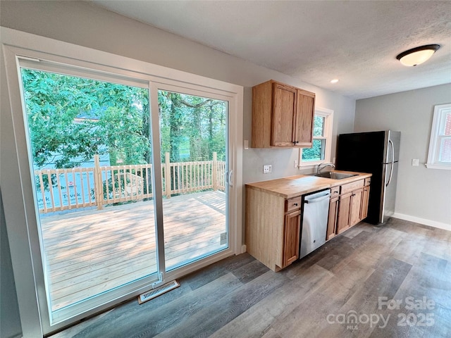 188 Johnston Blvd, Asheville, NC 28806 - kitchen featuring stainless steel appliances, wood finished floors, light countertops, a sink, and baseboards