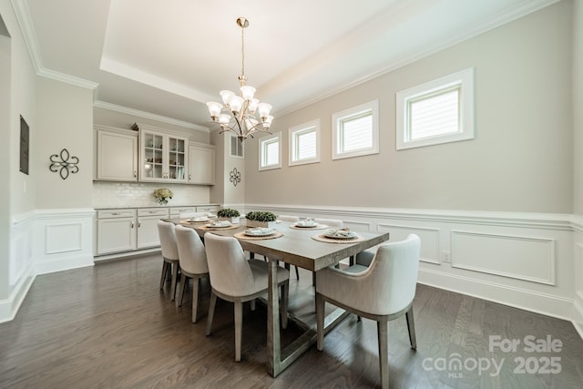 515 Lizzie Ln, Fort Mill, SC 29708 - dining room featuring a chandelier, a wainscoted wall, a tray ceiling, dark wood finished floors, and crown molding