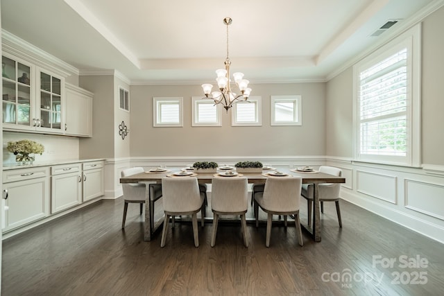 515 Lizzie Ln, Fort Mill, SC 29708 - dining area featuring a raised ceiling, a chandelier, dark wood-style flooring, a wainscoted wall, and a decorative wall