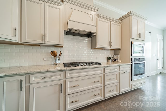 515 Lizzie Ln, Fort Mill, SC 29708 - kitchen featuring stainless steel appliances, ornamental molding, custom range hood, tasteful backsplash, and dark wood-style floors