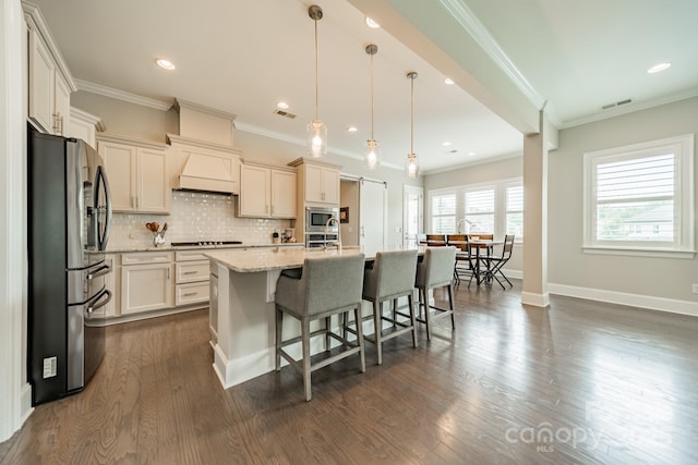 515 Lizzie Ln, Fort Mill, SC 29708 - kitchen with appliances with stainless steel finishes, backsplash, a breakfast bar area, a center island with sink, and dark wood-style flooring