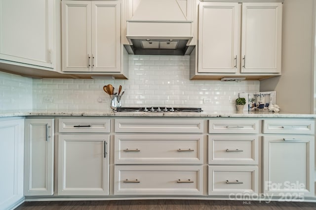 515 Lizzie Ln, Fort Mill, SC 29708 - kitchen with custom exhaust hood, stainless steel gas cooktop, tasteful backsplash, and light stone counters