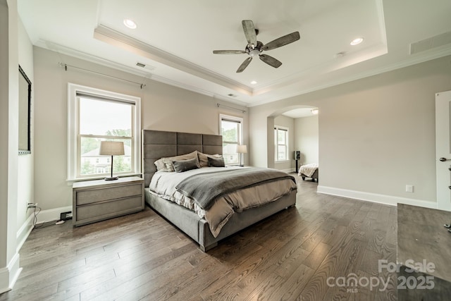 515 Lizzie Ln, Fort Mill, SC 29708 - bedroom featuring a raised ceiling, ornamental molding, arched walkways, hardwood / wood-style floors, and baseboards