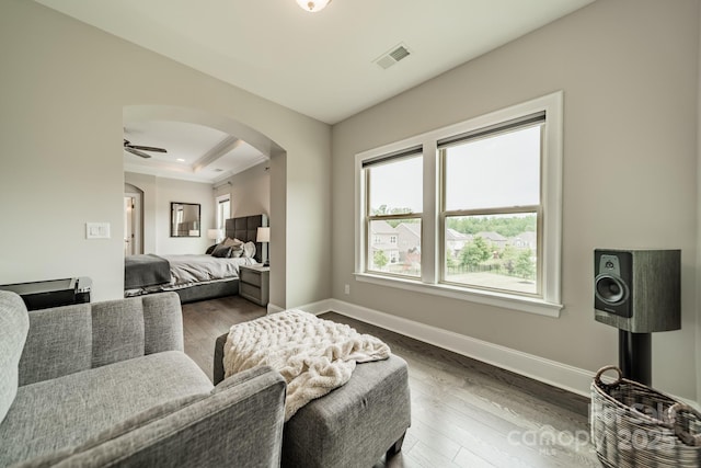 515 Lizzie Ln, Fort Mill, SC 29708 - living area with arched walkways, dark wood-style floors, a tray ceiling, ceiling fan, and baseboards