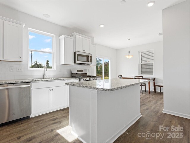 1433 Harleston St, Indian Trail, NC 28079 - kitchen featuring stainless steel appliances, backsplash, dark wood finished floors, white cabinetry, and recessed lighting