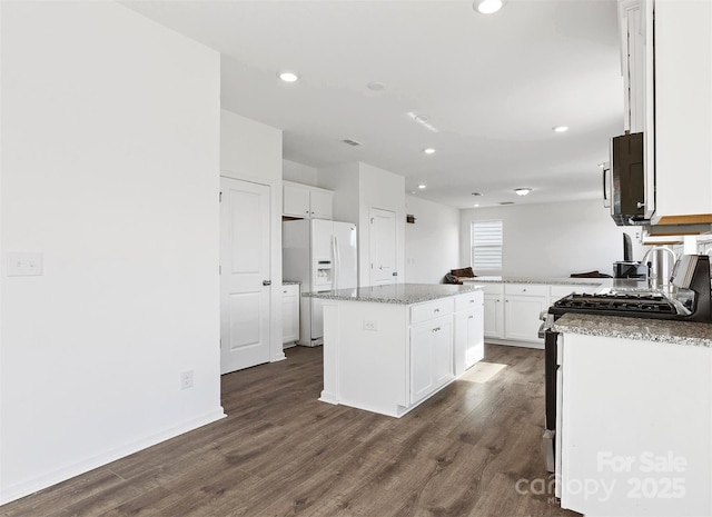 1433 Harleston St, Indian Trail, NC 28079 - kitchen with appliances with stainless steel finishes, dark wood-type flooring, white cabinetry, and recessed lighting
