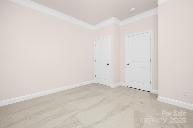 unfurnished bedroom featuring crown molding, light carpet, and baseboards