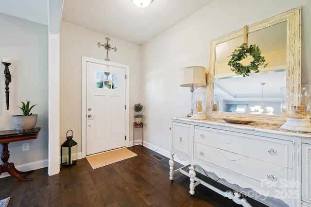 4151 Green Park Ct, Harrisburg, NC 28075 - foyer entrance featuring baseboards, dark wood-style flooring, a chandelier, and healthy amount of natural light