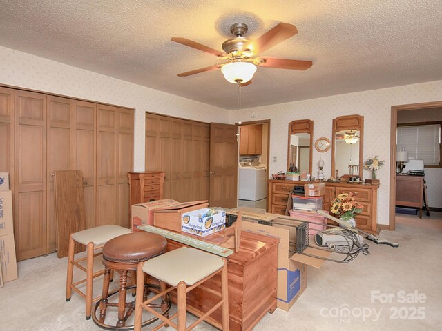 269 Johnson Dairy Rd, Mooresville, NC 28115 - dining area featuring washer / clothes dryer, wallpapered walls, a ceiling fan, light colored carpet, and a textured ceiling