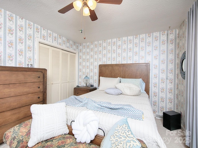 269 Johnson Dairy Rd, Mooresville, NC 28115 - bedroom featuring wallpapered walls, a closet, a textured ceiling, and a ceiling fan