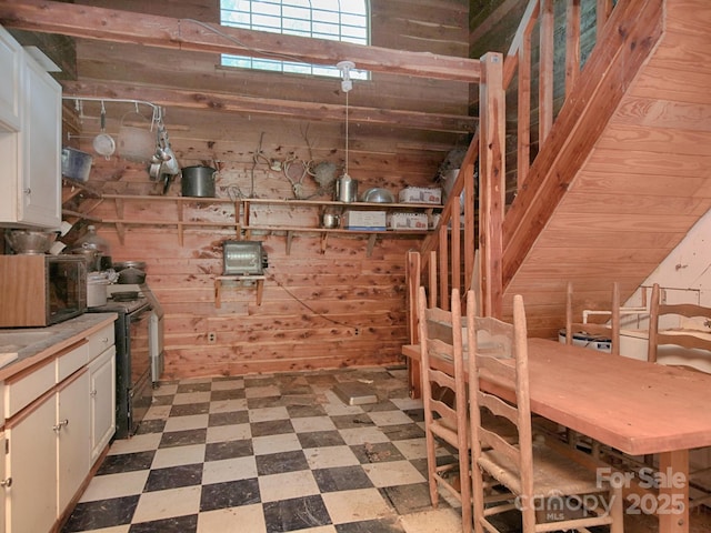 269 Johnson Dairy Rd, Mooresville, NC 28115 - below grade area featuring tile patterned floors and wood walls