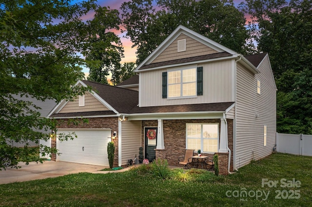 413 Wheat Field Dr, Mount Holly, NC 28120 - view of front of house featuring covered porch, a garage, driveway, and a shingled roof