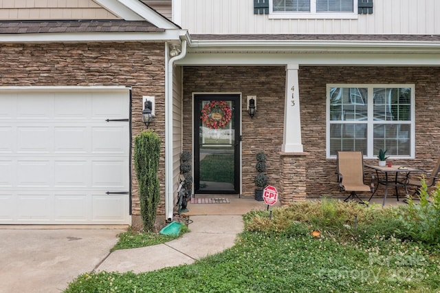 413 Wheat Field Dr, Mount Holly, NC 28120 - entrance to property with stone siding, board and batten siding, covered porch, and an attached garage