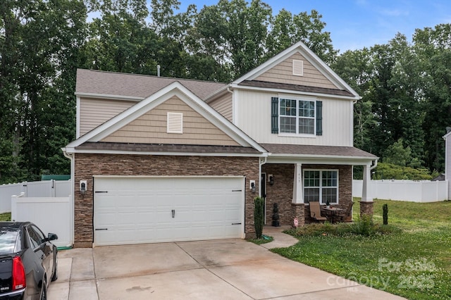 413 Wheat Field Dr, Mount Holly, NC 28120 - view of front of house featuring driveway, stone siding, a porch, a garage, and a shingled roof