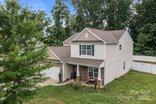 413 Wheat Field Dr, Mount Holly, NC 28120 - view of front of home featuring a garage, a porch, concrete driveway, roof with shingles, and stone siding