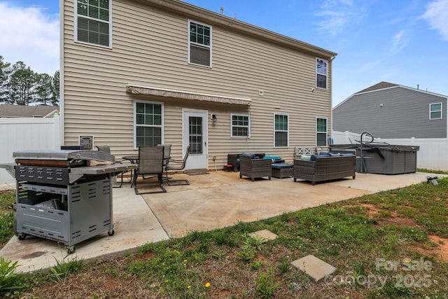 413 Wheat Field Dr, Mount Holly, NC 28120 - back of property with an outdoor living space, a patio area, and a hot tub