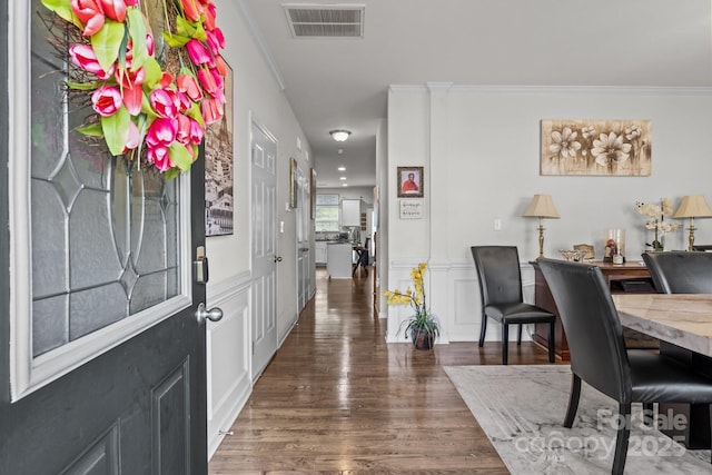 413 Wheat Field Dr, Mount Holly, NC 28120 - foyer entrance featuring wood finished floors, ornamental molding, a wainscoted wall, and a decorative wall