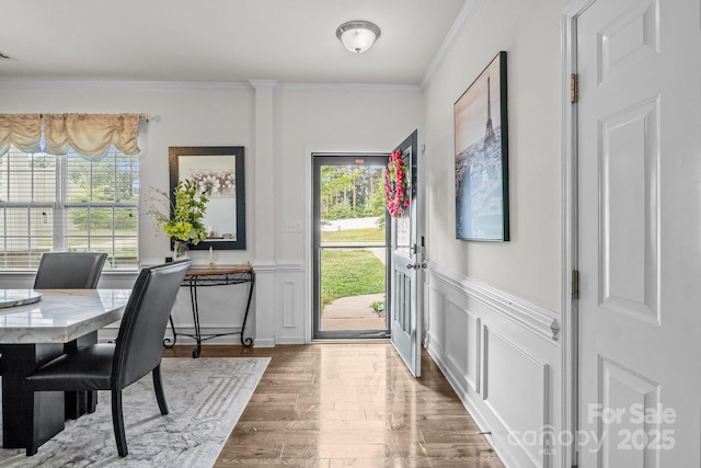 413 Wheat Field Dr, Mount Holly, NC 28120 - foyer featuring wood finished floors, crown molding, a wainscoted wall, and a decorative wall