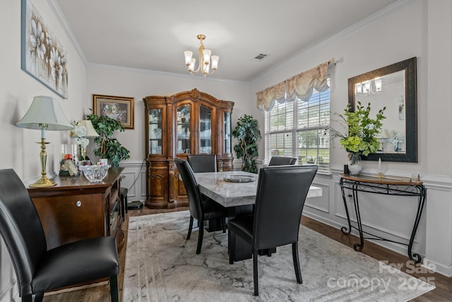 413 Wheat Field Dr, Mount Holly, NC 28120 - dining area with a chandelier, ornamental molding, wood finished floors, and wainscoting