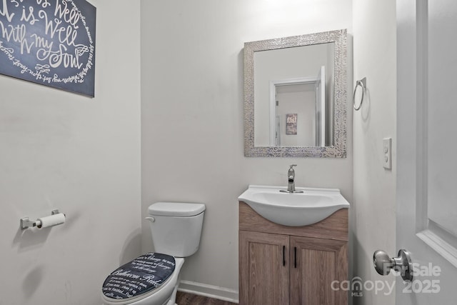 413 Wheat Field Dr, Mount Holly, NC 28120 - half bathroom with toilet, vanity, and wood finished floors