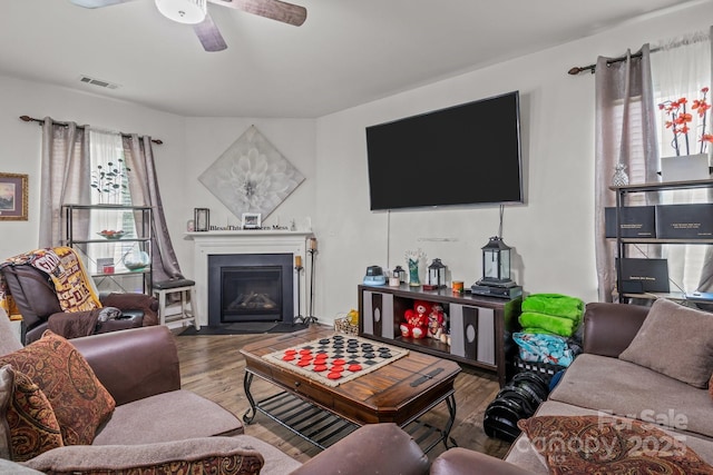 413 Wheat Field Dr, Mount Holly, NC 28120 - living room with wood finished floors, a fireplace with flush hearth, and ceiling fan