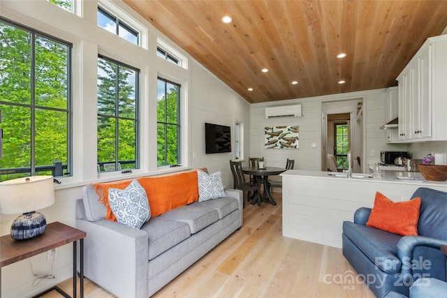 living area featuring wooden ceiling, a wall mounted AC, healthy amount of natural light, recessed lighting, and light wood-style floors