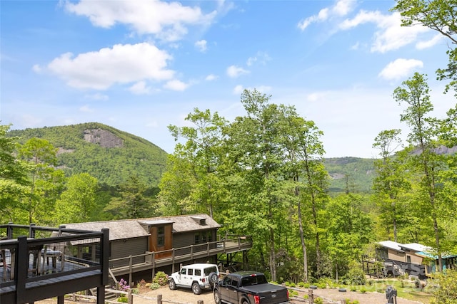 view of mountain background with a heavily wooded area