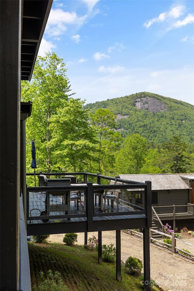 wooden deck with a wooded view
