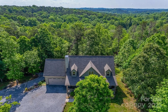 view from above of property with a heavily wooded area