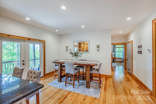 dining space featuring french doors, light wood-type flooring, recessed lighting, and baseboards