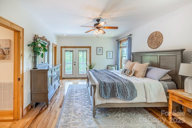 bedroom with light wood-style floors, access to exterior, ceiling fan, and french doors