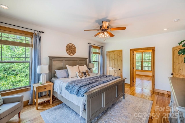 bedroom with light wood finished floors, recessed lighting, and a ceiling fan