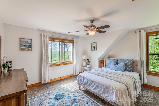 carpeted bedroom featuring baseboards and a ceiling fan