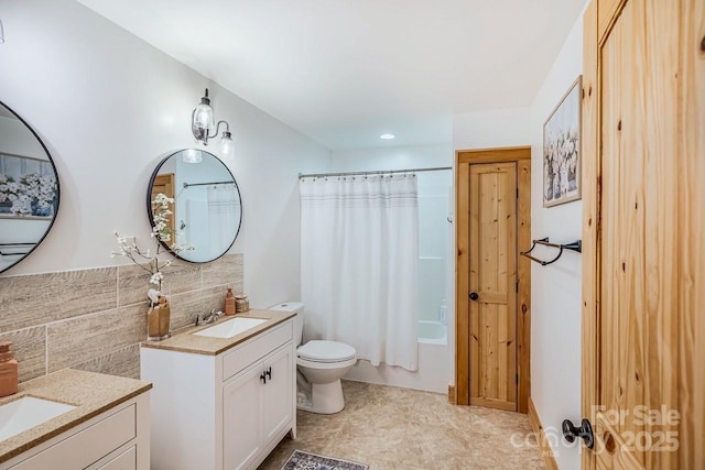 bathroom with decorative backsplash, toilet, vanity, shower / bath combo, and recessed lighting