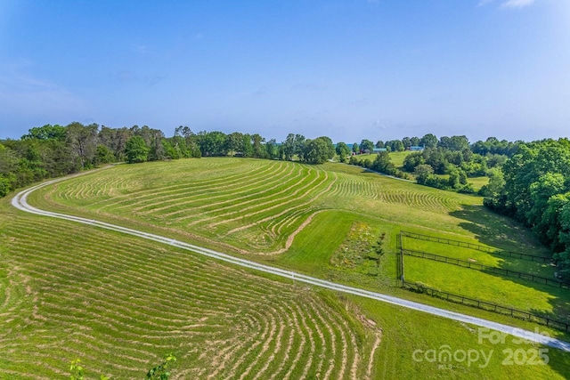 view of rural area with a tree filled landscape
