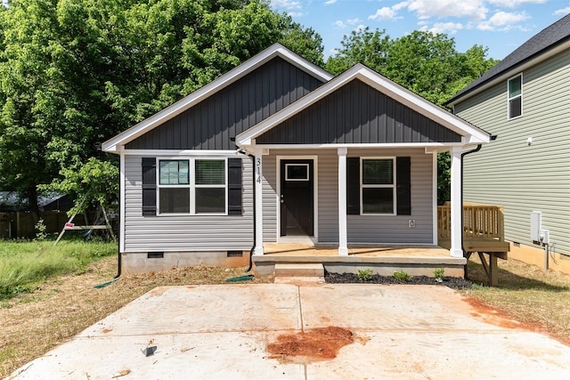 bungalow with crawl space, board and batten siding, and a porch