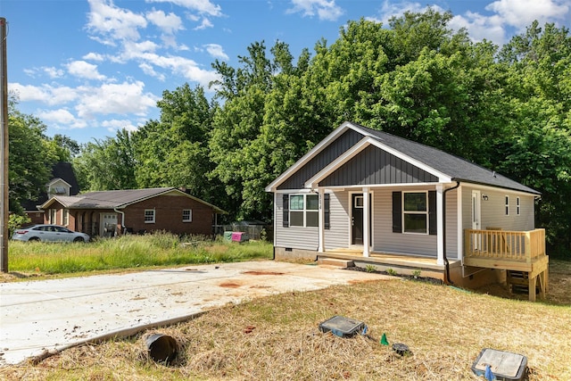 view of front of house with crawl space, board and batten siding, and covered porch