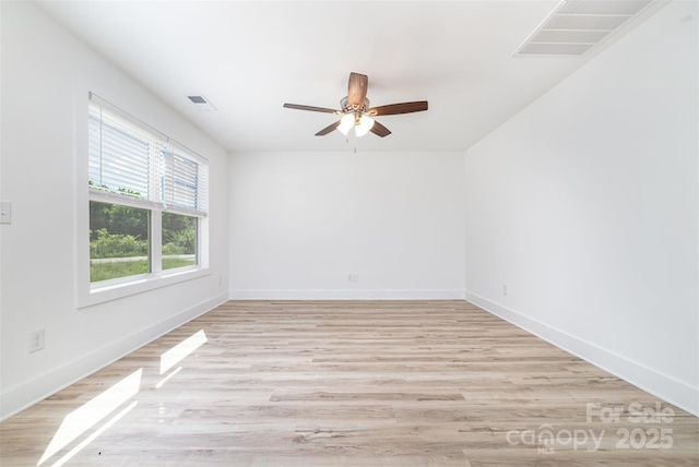 unfurnished room with a ceiling fan, baseboards, and light wood-type flooring