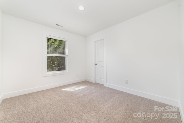 spare room with carpet floors, baseboards, and recessed lighting