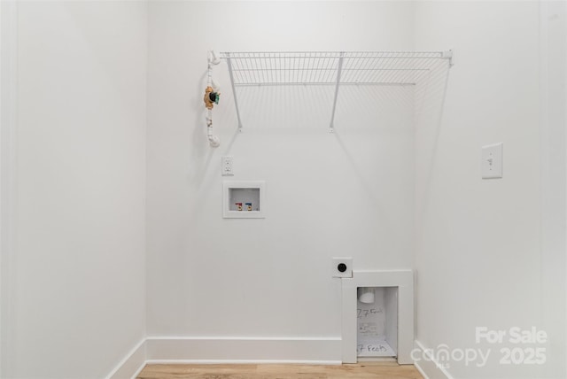 washroom featuring hookup for an electric dryer, light wood finished floors, washer hookup, and baseboards