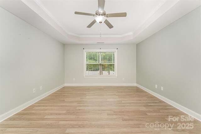 140 Wintergreen Ct, Lexington, NC 27295 - empty room featuring a raised ceiling, light wood finished floors, crown molding, ceiling fan, and baseboards