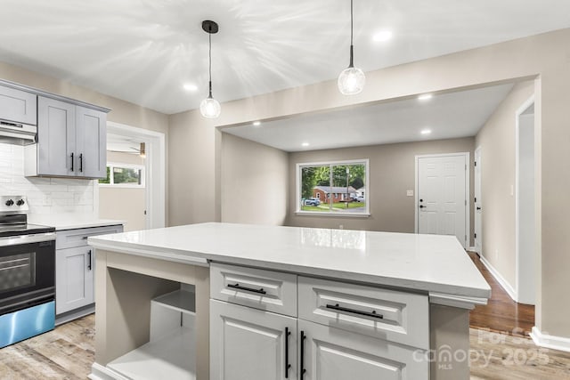 316 Fulton St, Kings Mountain, NC 28086 - kitchen with stainless steel range with electric stovetop, light wood-style flooring, decorative backsplash, plenty of natural light, and recessed lighting