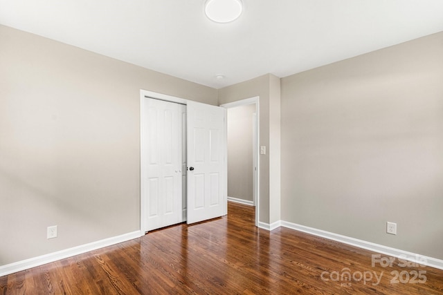 316 Fulton St, Kings Mountain, NC 28086 - unfurnished bedroom featuring baseboards, wood finished floors, and a closet