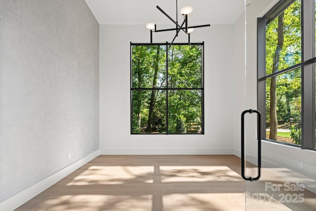 78 Running Creek Trl Unit 93, Arden, NC 28704 - unfurnished dining area featuring wood finished floors, a chandelier, and baseboards