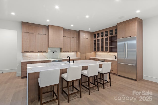 78 Running Creek Trl Unit 93, Arden, NC 28704 - kitchen featuring built in refrigerator, light wood-style floors, backsplash, recessed lighting, and a center island with sink