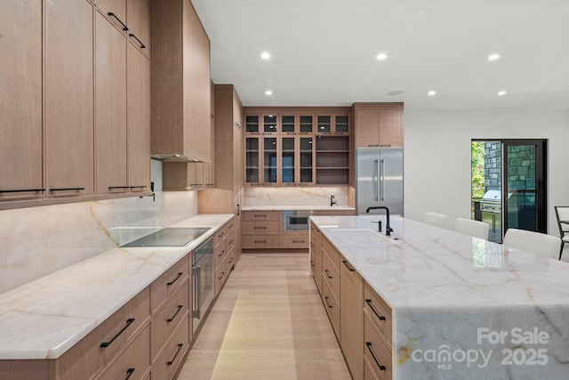 78 Running Creek Trl Unit 93, Arden, NC 28704 - kitchen with built in refrigerator, black electric stovetop, a sink, recessed lighting, and a large island with sink