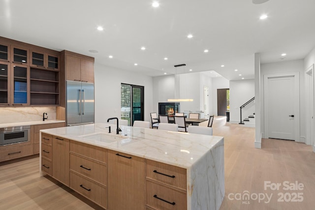 78 Running Creek Trl Unit 93, Arden, NC 28704 - kitchen featuring appliances with stainless steel finishes, a sink, a large island with sink, recessed lighting, and light wood finished floors